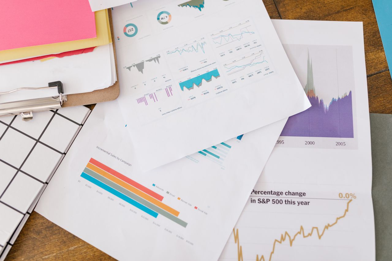 Crafting Captivating Headlines: Your awesome post title goes here Close-up of business analytics charts and graphs on papers and clipboard.